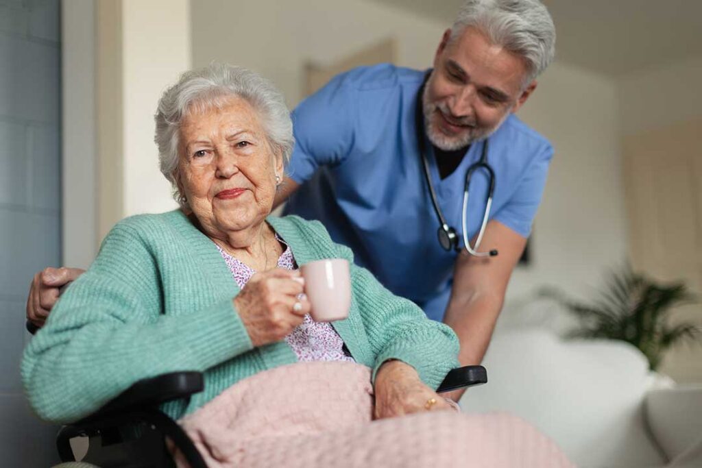 Family members sit with an older adult in a bright assisted living room, reviewing a care plan together.